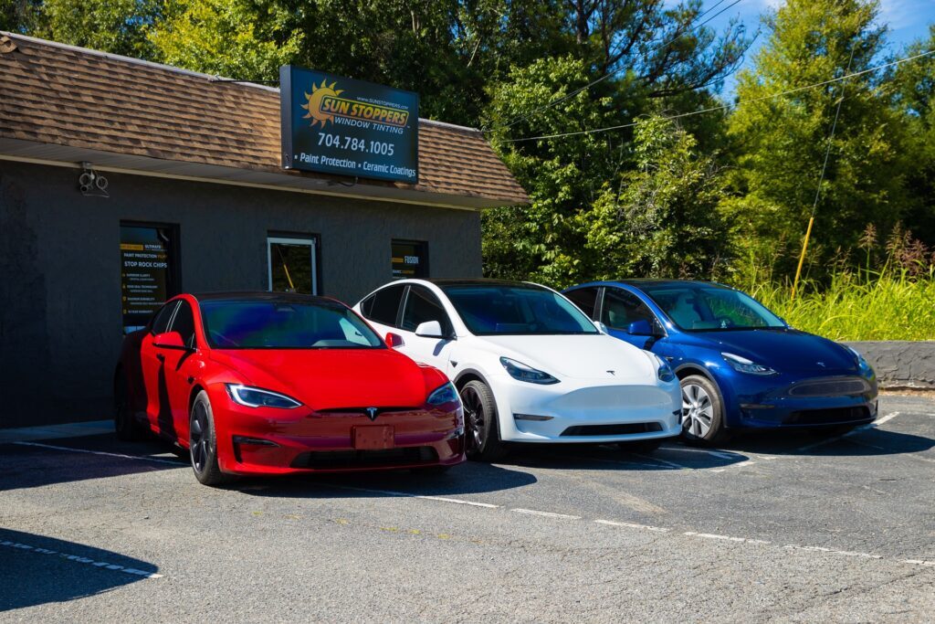 Tesla cars parked outside Sun Stoppers shop
