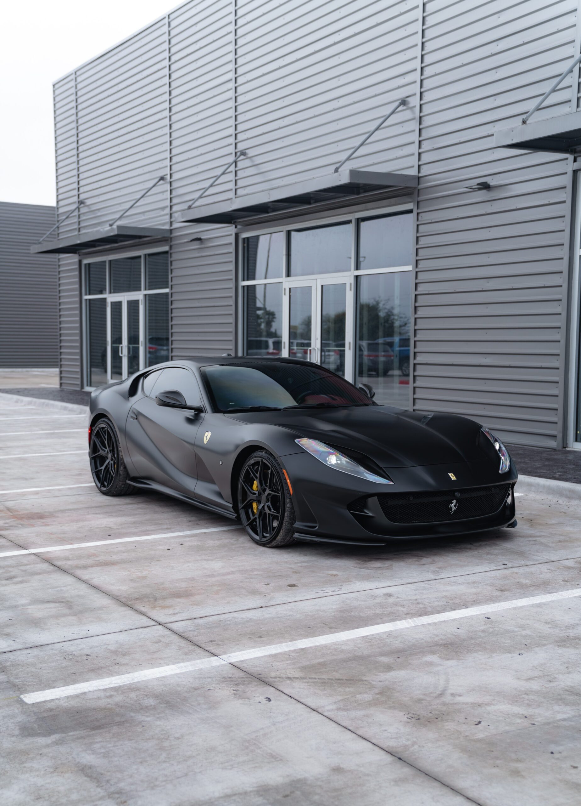 Black Ferrari 812 with window tint outside Sun Stoppers