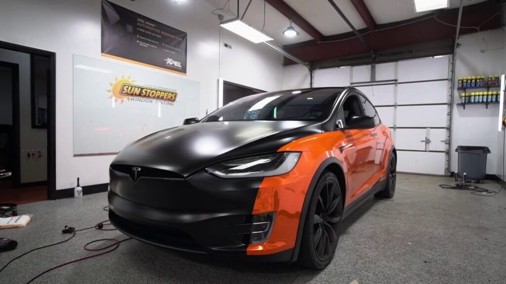 a black and orange tesla with paint protection