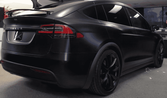 A black Model 3 Tesla with full window tint