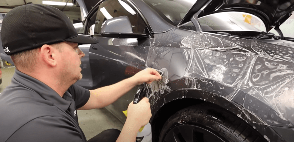 cleaning a Tesla before putting on XPEL paint protection film