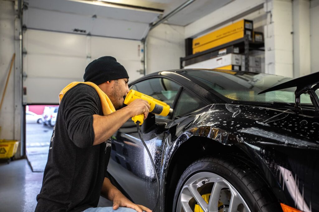 applying paint protection to a black car