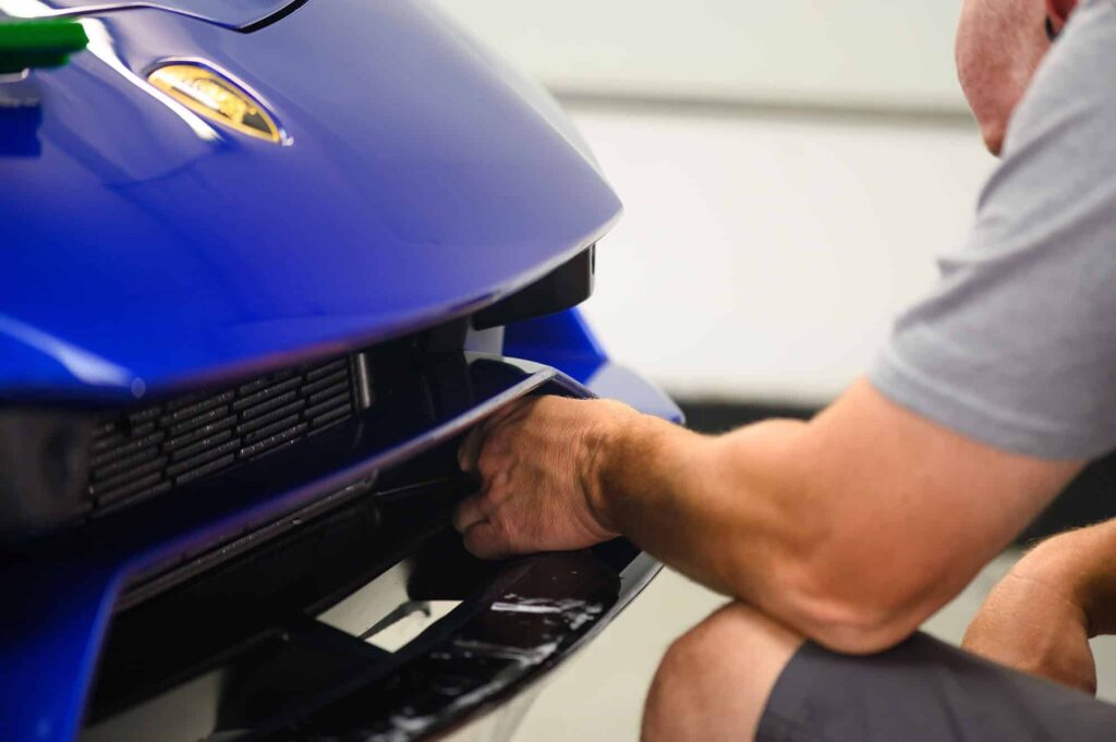 a blue car getting a fresh coat of ppf