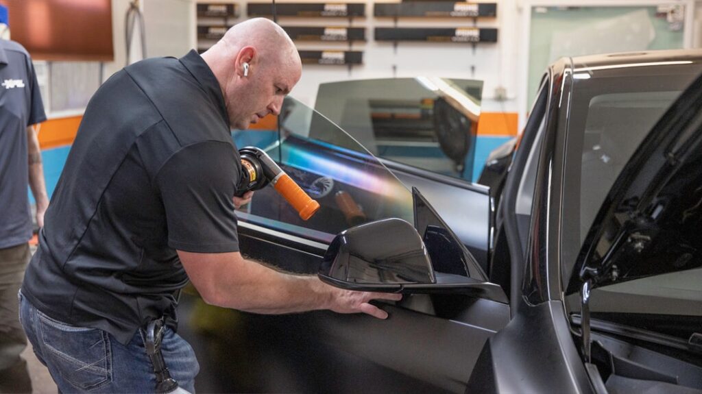 Sun Stoppers team putting paint protection film on a Tesla