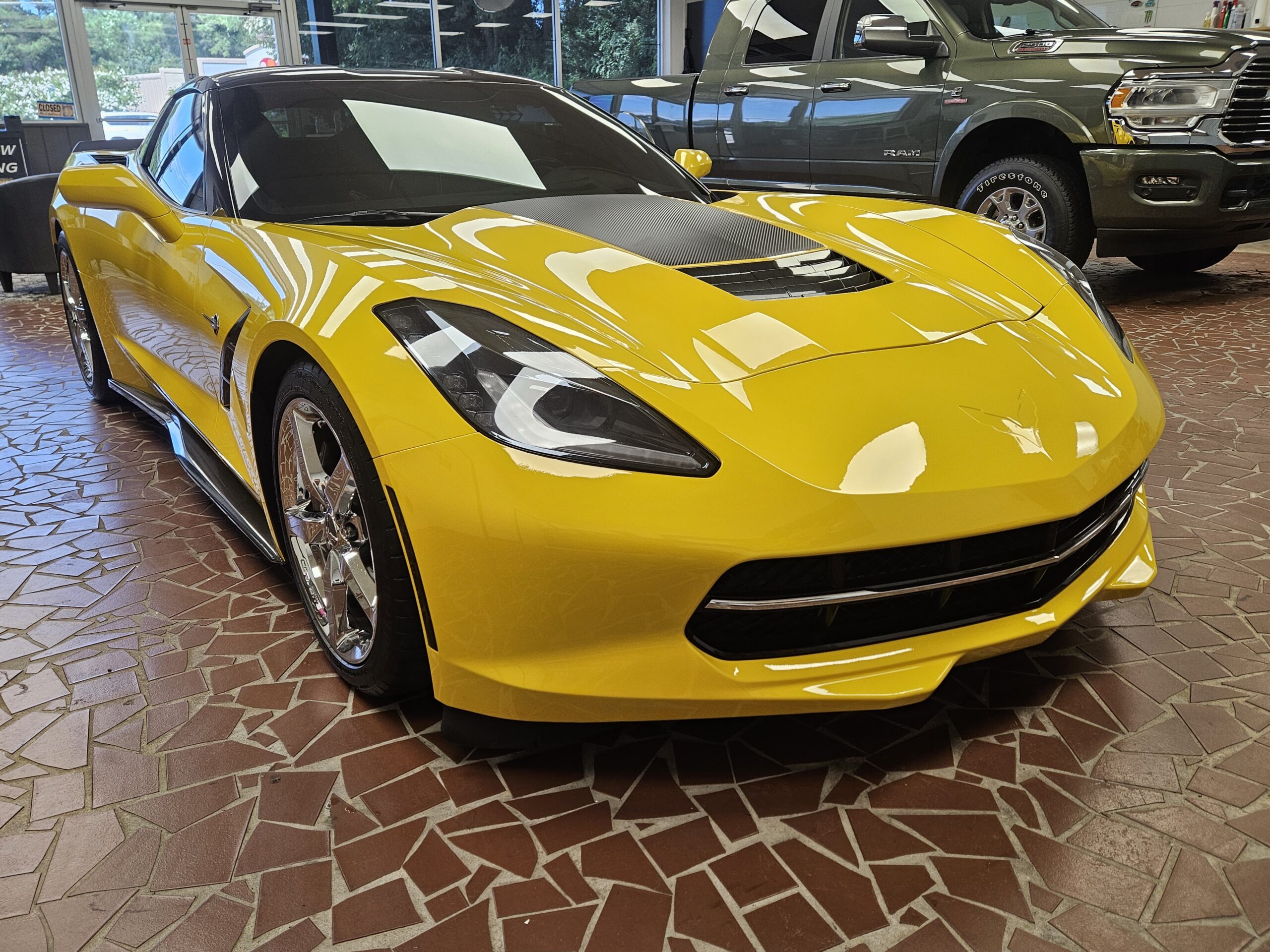 Yellow Chevrolet Corvette inside showroom