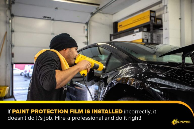a professional installs paint protection film on a vehicle