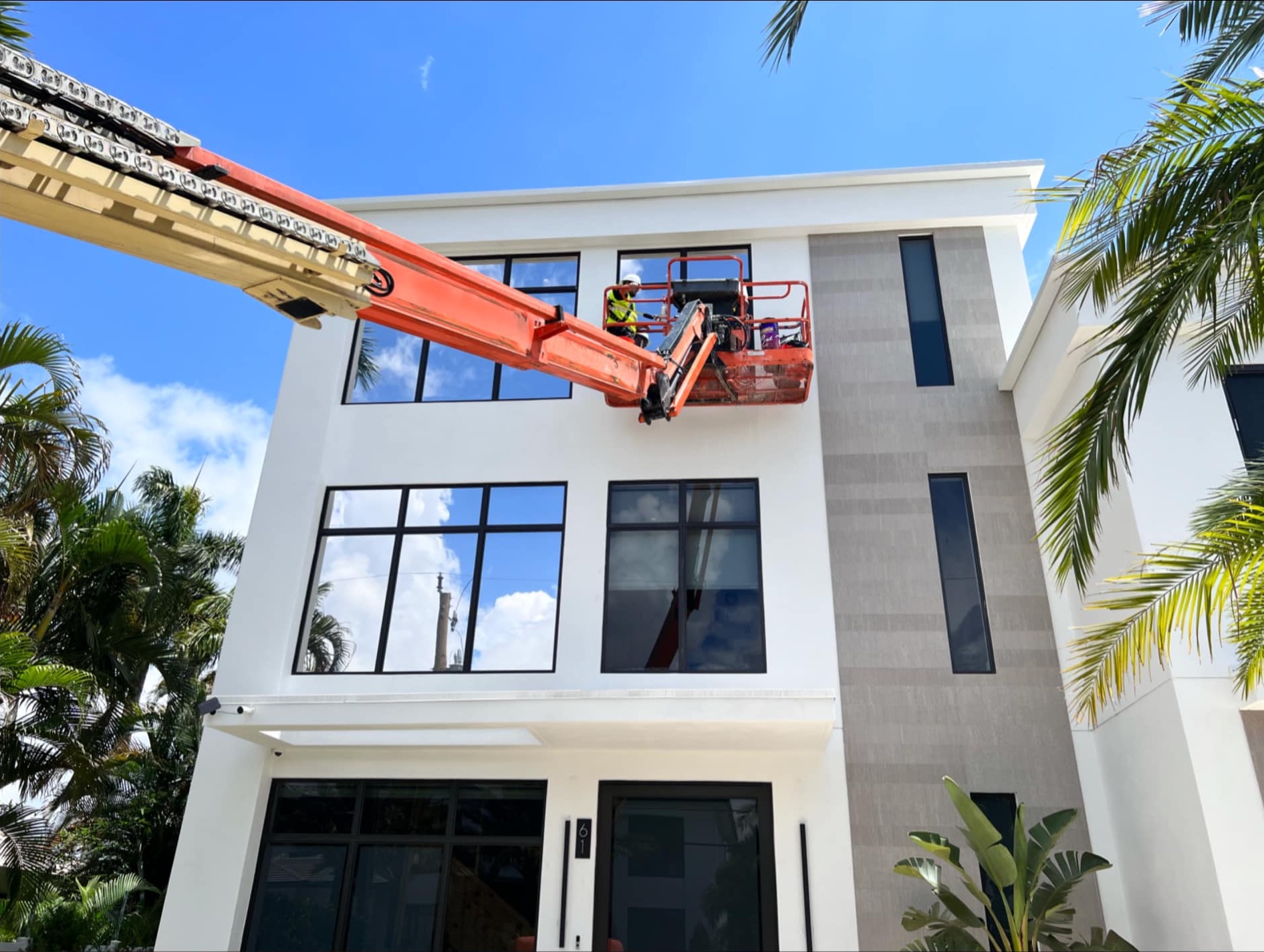 Installing tinted windows on three story home.